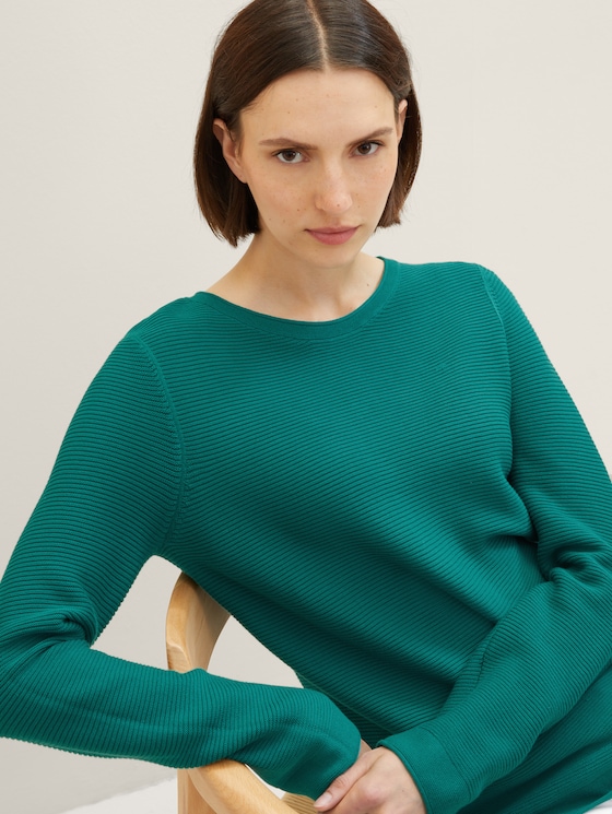 Knitted sweater with a round neckline