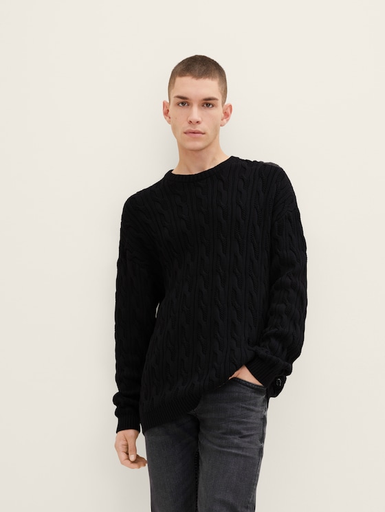 Knitted sweater in a cable knit pattern