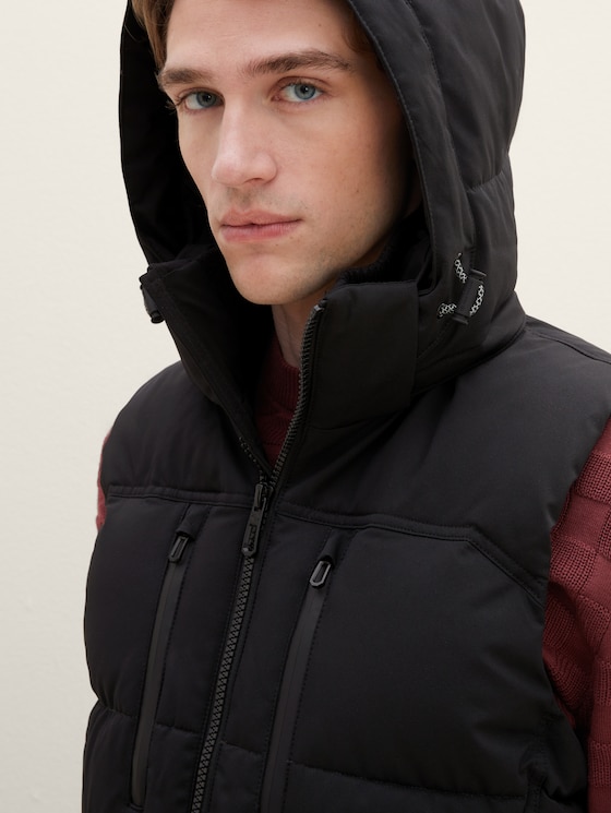 Puffer vest with a removable hood
