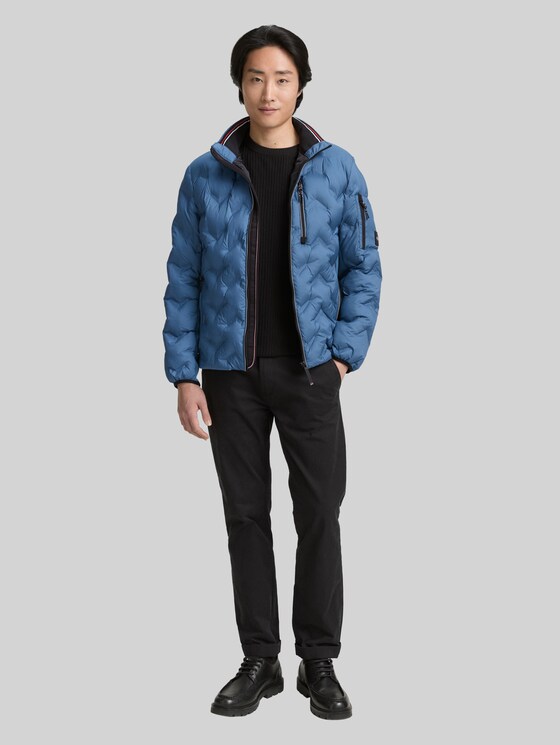 Hybrid lightweight quilted jacket with stowable hood in blue by