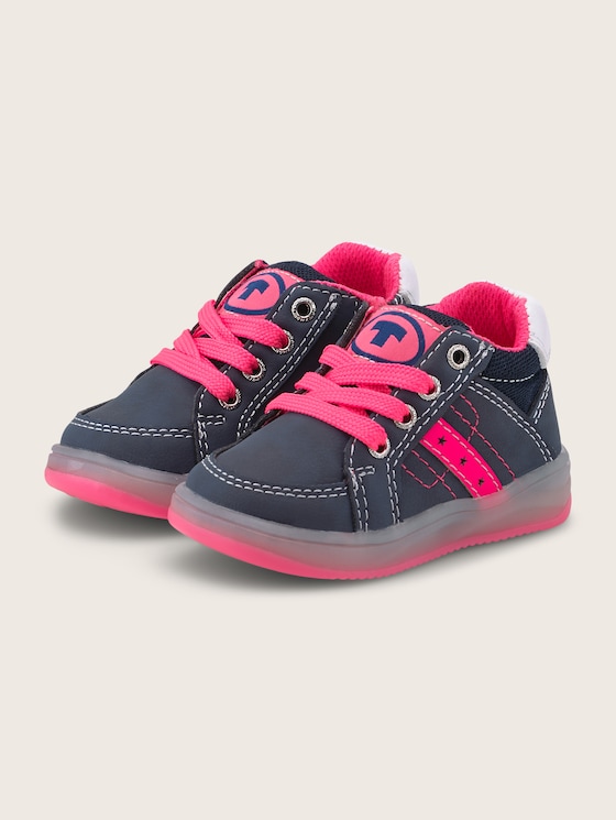Sneakers with a logo print and neon colour accents
