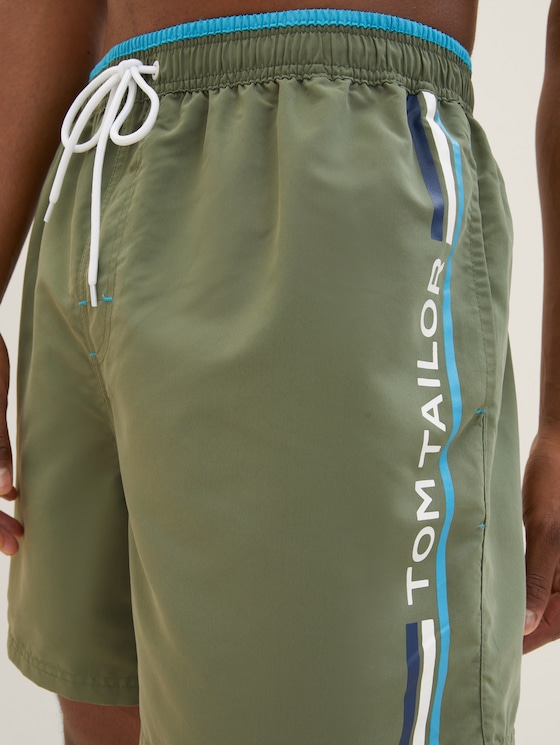 Swimming trunks with a logo print
