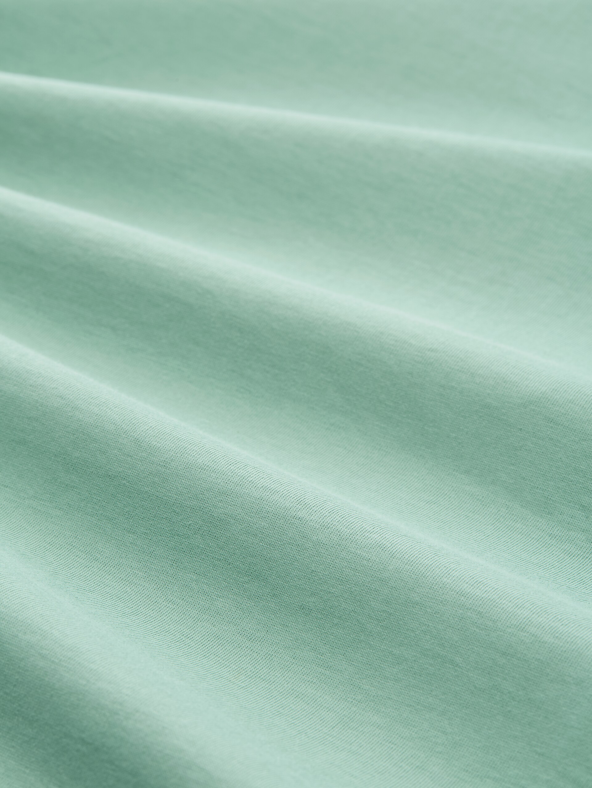 T-Shirt mit Print - dust green - Material-Ansicht