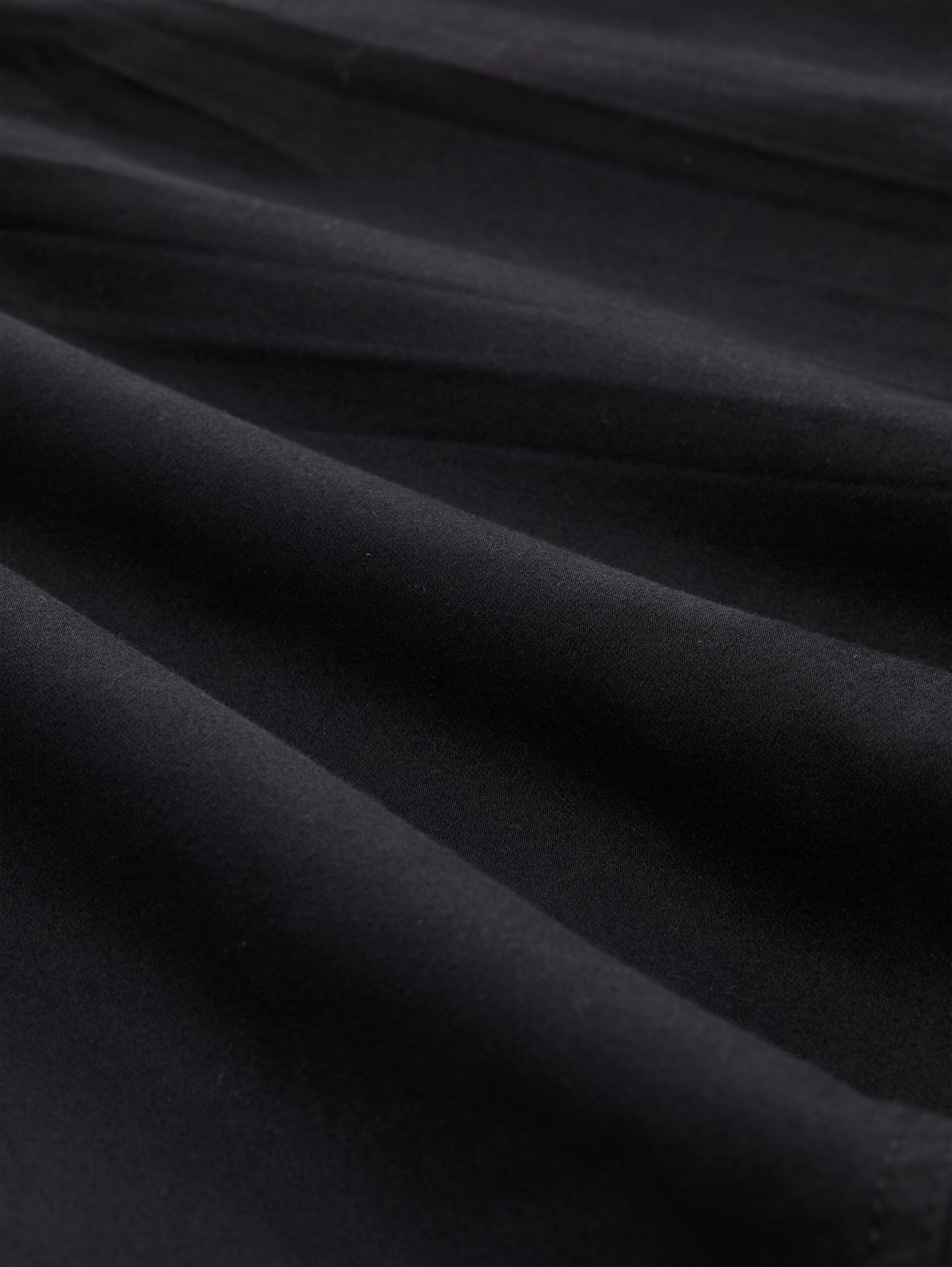 Pantalon fuselé et ample - deep black - Vue de la matière