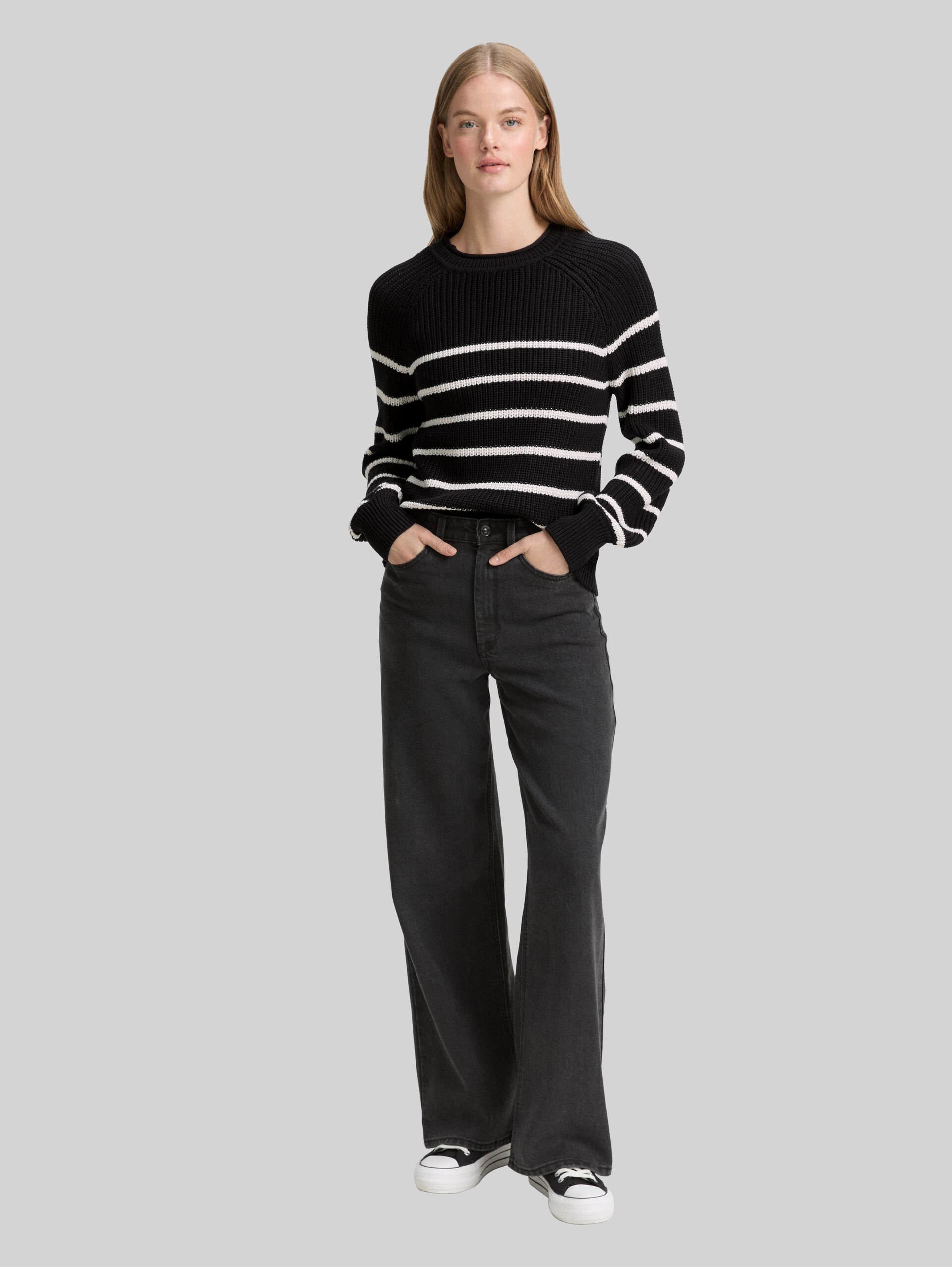 Knitted jumper with slightly puffed sleeves - placed black white stripe - Model front view