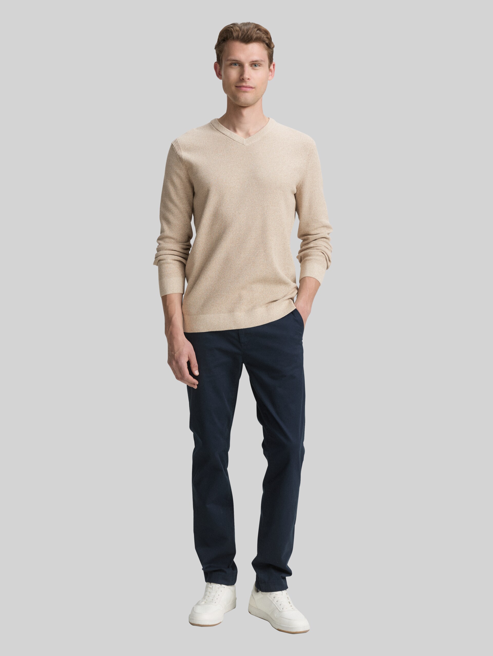 Knitted jumper with V-neck made from organic cotton - beige offwhite twotone - Model front view