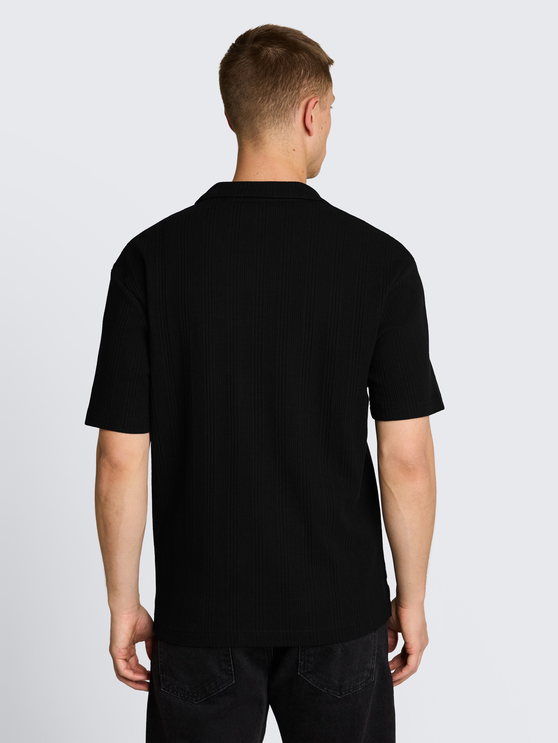 Poloshirt met relaxte pasvorm en wafelstructuur - Black